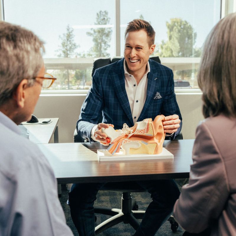 audiologist talking to two patients